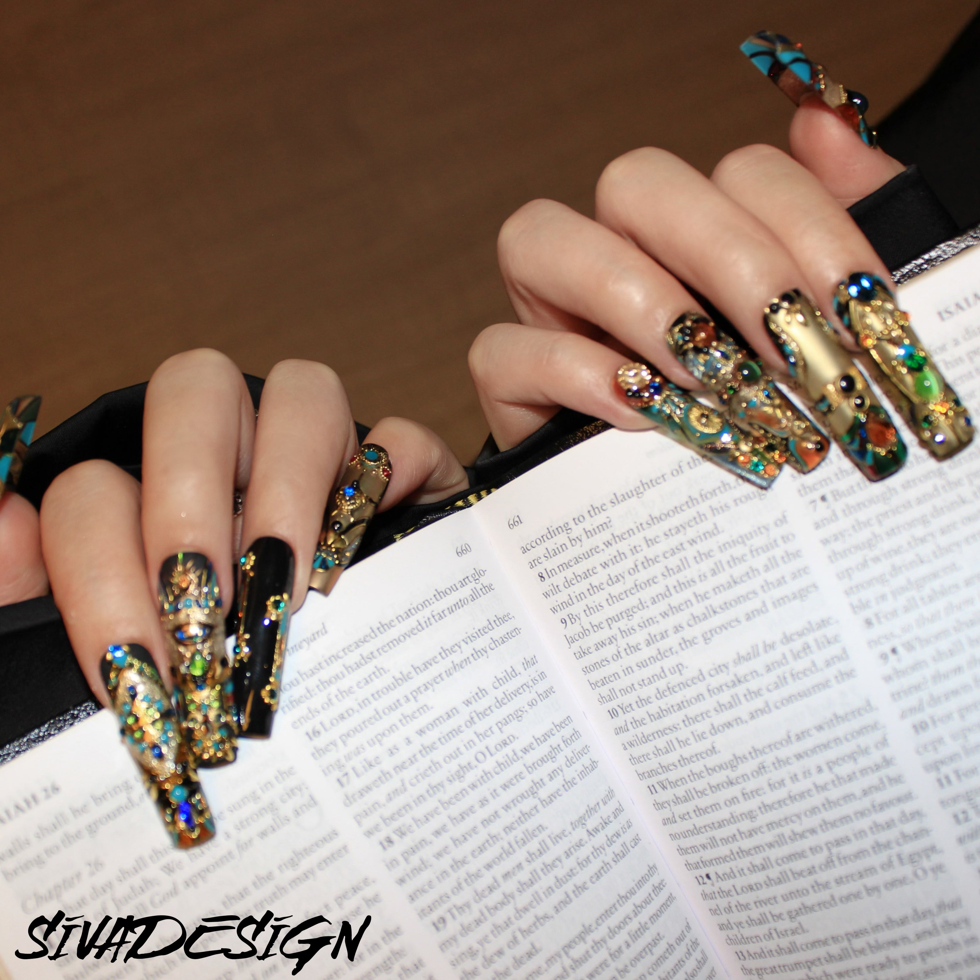 Metallic press-on nails with elaborate gold and gemstone designs, offering a high-end, artistic look